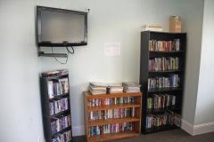 Media room and lounge with DVD library and flatscreen TV at Third and Main