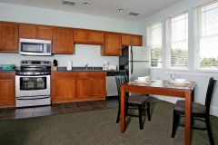 Modern kitchen and dinette with large windows at Third & Main